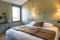 a bedroom with a large bed with a window at Château de Pierreclos in Pierreclos