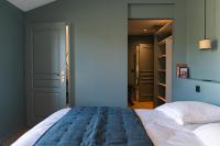 a bedroom with a large bed and a closet at Château de Pierreclos in Pierreclos