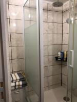 a shower with a glass door in a bathroom at ila’s tiny house in Limoges
