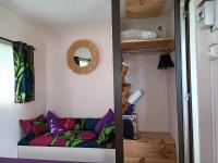 a small room with a couch in a tiny house at Chabatz d entraz in Lubersac