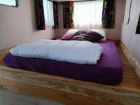 a large bed sitting on a wooden platform in a bedroom at Chabatz d entraz in Lubersac