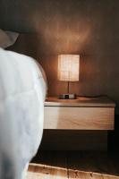 a bedside table with a lamp on top of it at F3 Av république avec garage (c) in Clermont-Ferrand