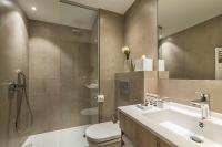 a bathroom with a sink and a toilet and a shower at Hôtel La Villa Douce in Rayol-Canadel-sur-Mer