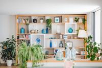 a shelf filled with lots of plants and blue vases at Hôtel La Villa Douce in Rayol-Canadel-sur-Mer