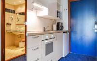 a kitchen with white cabinets and a blue door at Stunning Apartment In Helsingr With Wifi in Helsingør