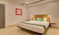 a bedroom with a large bed in a room at Treebo De Alphabet Kondapur in Hyderabad