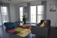 a living room with a couch and a colorful rug at Panorama Apartman in Velence