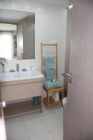 a bathroom with a sink and a mirror and a toilet at Panorama Apartman in Velence