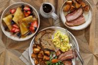 three plates of breakfast food on a wooden table at Jackson's Falls Country Inn in Milford
