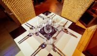 a table with wine glasses and spoons on it at Trois Ore Residences & Green Earth Bistro in Ibadan
