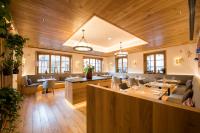 a restaurant with wooden ceilings and tables and chairs at Hostellerie Des Châteaux & Spa in Ottrott