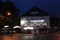 a white building with a sign on it at night at Gasthaus &amp; Hotel Grünhof in Frankfurt Oder