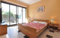 a bedroom with a bed and a large window at 1 Bedroom Awesome Apartment In Le Cannet in Le Cannet