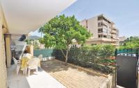 a balcony with a table and chairs and a tree at 1 Bedroom Awesome Apartment In Le Cannet in Le Cannet