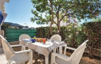 a table and chairs on a patio with a tree at 1 Bedroom Awesome Apartment In Le Cannet in Le Cannet