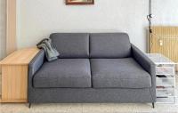 a gray couch in a room with a table at 1 Bedroom Awesome Apartment In Le Cannet in Le Cannet