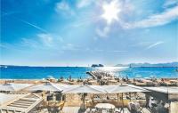 a beach with chairs and umbrellas and the ocean at 1 Bedroom Awesome Apartment In Le Cannet in Le Cannet