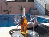 a bottle of champagne and two wine glasses on a table at Jasmine loft luxury 1 in Kokkini Khanion