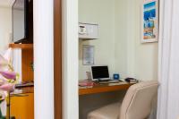 a room with a desk with a laptop computer on it at Hotel Santorini in Vila Velha