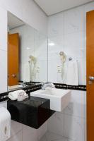 a bathroom with a sink and a mirror at Hotel Santorini in Vila Velha