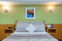 a bedroom with a large bed with two night stands at Hotel Santorini in Vila Velha
