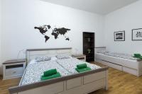 a bedroom with two beds with a world map on the wall at Relax Apartment Vienna City Center in Vienna