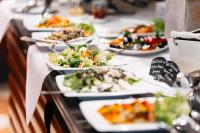 a buffet line of plates of food on a table at City Park Hotel in Frankfurt Oder