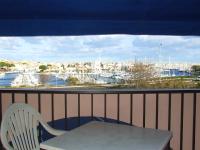 a white chair and a table on a balcony with a view at Hotel Alhambra in Cap d&#39;Agde