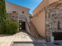 a stone building with a staircase next to a building at Holiday Home Chez Béatrice et Pascal by Interhome in Belgodère