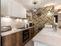 a kitchen with white cabinets and a sink at Holiday Home Chez Béatrice et Pascal by Interhome in Belgodère