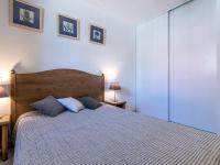 a bedroom with a bed with two blue pillows at Holiday Home Chez Béatrice et Pascal by Interhome in Belgodère