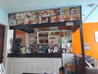 a restaurant with a bar with plates of food at Arthur Private Resort in Legazpi