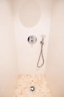 a bathroom with a shower with a tiled floor at L&#39;appartement du Cellier in Pommard