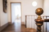 a close up of a wooden rail in a room with a hallway at L&#39;appartement du Cellier in Pommard
