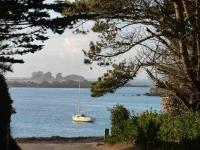 a sailboat in the middle of a large body of water at Kerletty, la mer, les embruns, à 250 m des plages in Plouguerneau