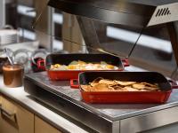 two trays of food on a counter in a kitchen at Pinia Hotel & Resort in Špindlerův Mlýn
