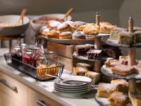 a buffet filled with different types of cakes and pastries at Pinia Hotel & Resort in Špindlerův Mlýn