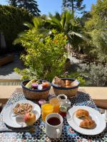a table with breakfast foods and drinks on it at Hotel Alexandra - Boutique Hotel in Juan-les-Pins