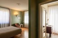 A bed or beds in a room at Relais Villa Borghetto
