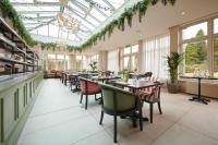 a dining room with tables and chairs and windows at Cromlix in Kinbuck