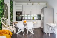 a kitchen with white chairs and a table and a refrigerator at Apt 6P - Standing RER Tram Paris Orly Velizy in Le Plessis-Robinson