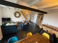 a living room with blue couches and a table at Le Planzollais in Planzolles