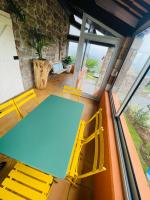 a table and chairs in a room with a window at Le Planzollais in Planzolles