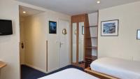 a small room with a bed and a closet at Hotel Le Marin in Auray