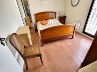 a bedroom with a bed and a chair and a table at Appartement Six-Fours-les-Plages, 2 pièces, 5 personnes - FR-1-316-118 in Six-Fours-les-Plages
