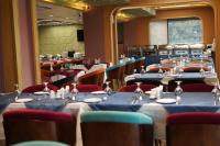 a dining room with tables and chairs with blue table cloth at The Zabeer Dhaka in Dhaka