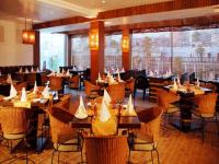 a restaurant with tables and chairs in a room at Hotel Palace Heights in New Delhi