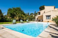 a swimming pool in front of a house at SERRENDY Calm family house with swimming pool in Antibes