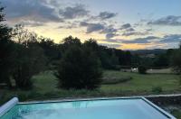 a swimming pool with a view of a field at Une pause en Corrèze in Sarroux