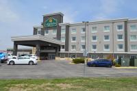 a large building with cars parked in a parking lot at La Quinta by Wyndham Rochester Mayo Clinic Area South in Rochester